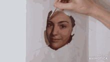 a painting of a woman 's face is being made by animatica
