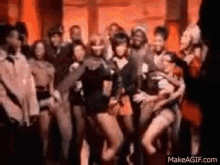 a group of people are dancing together in a room in a blurry photo .
