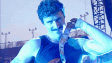 a man with a mustache is wearing a tie that says fender