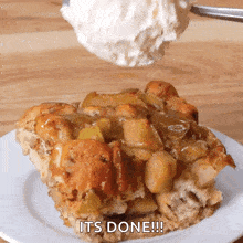 a piece of bread pudding on a white plate with the words it 's done