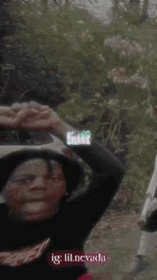 a man wearing a black sweater with the word shake on it