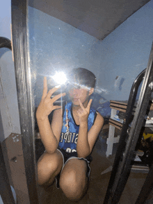 a person taking a picture of themselves in a mirror wearing a jersey that says 94012