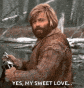 a man with a beard is holding a camera and saying `` yes , my sweet love ... ''