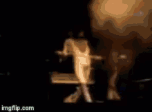 a blurry picture of a woman dancing on a stage with imgflip.com in the corner