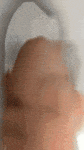 a blurry picture of a person 's head with a white headphone on