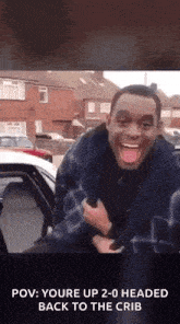 a man is making a funny face while sitting in the back of a car ..