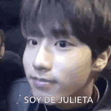 a close up of a person 's face with the words `` soy de julieta '' written on the bottom .