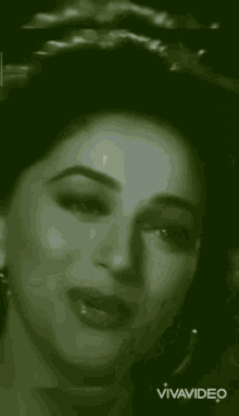a black and white photo of a smiling woman with the words vivavideo on the bottom right