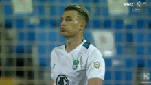 soccer player wearing a white shirt with a md logo on the sleeve