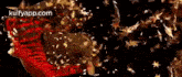 a close up of a red and gold object with the words kulfyapp.com in the corner