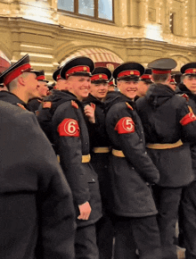 a group of men in military uniforms with the number 6 on their arm