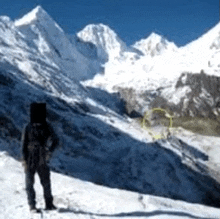 a person standing on a snow covered mountain