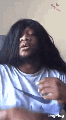 a man wearing a wig and a nike shirt is making a funny face