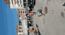 a man and two women are standing on a sidewalk in front of a building that says ' smirnoff ' on it