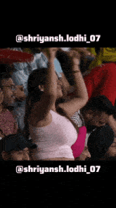 a woman in a pink tank top stands in a crowd of people with the hashtag shriyansh.lodhi_07 on the bottom