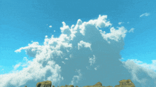 a large cloud in the sky over a rocky area