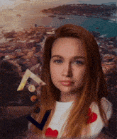 a woman with red hair is standing in front of a city with boats in the water
