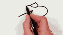 a person is holding a marker in their right hand and writing on a piece of paper