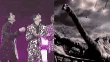 a couple of men standing next to each other on a stage next to a black and white photo of a person 's arm .