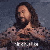 a man with a beard wearing a polka dot shirt says " this girl i like "