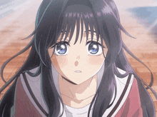 a girl with long black hair and blue eyes looks at the camera