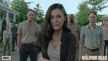 a group of people standing next to each other with the walking dead written on the bottom