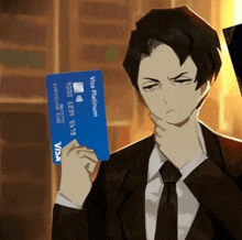 a man in a suit holds a visa platinum credit card