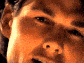 a close up of a man 's face with his mouth open and eyes closed .