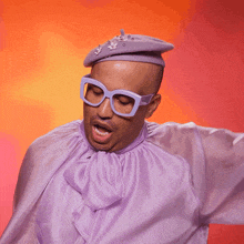 a man wearing glasses and a purple shirt with the word swish written on it