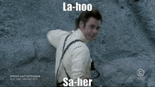 a man is climbing up a rock wall with a caption that says la-hoo