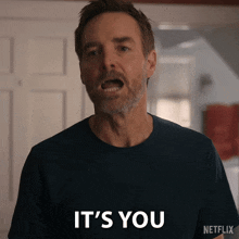 a man says it 's you while wearing a netflix shirt