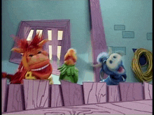 a group of cartoon characters are standing behind a wooden fence with a hose in the background