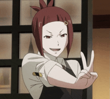 a woman with red hair is making a peace sign with her hands