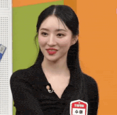 a woman in a black shirt has a name tag that says suha