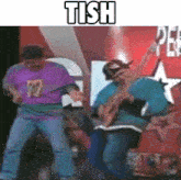 two men are dancing on a stage with the words tish above them