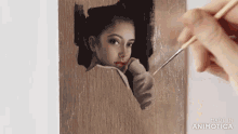 a person is painting a picture of a woman with the words made in animotica below it