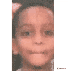 a close up of a child 's face with the word kapwing on the bottom right