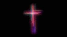 a colorful cross on a black background that looks like it is glowing