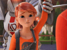 a girl with red hair is wearing an orange shirt that says id