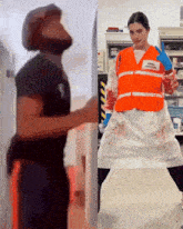 a man and a woman are standing next to each other and the woman is wearing an orange vest that says emergency response
