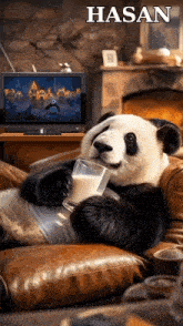 a panda bear is sitting on a couch with a glass of milk in front of a tv screen that says hasan