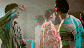 a group of people are wearing headphones and dancing in a room .