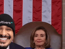 a man wearing a cultivars hat sits next to a woman in a chair