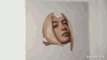 a person is painting a woman 's face on a canvas with a pencil .