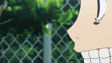 a close up of a person 's face with a chain link fence behind it
