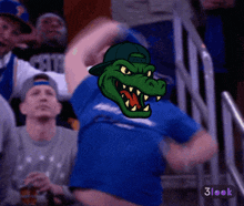 a man wearing a blue shirt with a crocodile on his shirt