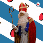 a man in a santa costume holds a cane in front of a blue and white background