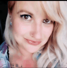 a woman with a nose ring and a tattoo on her chest