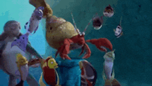 a group of cartoon fish and a crab are swimming in the ocean .