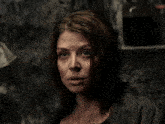 a close up of a woman 's face with a serious look on her face